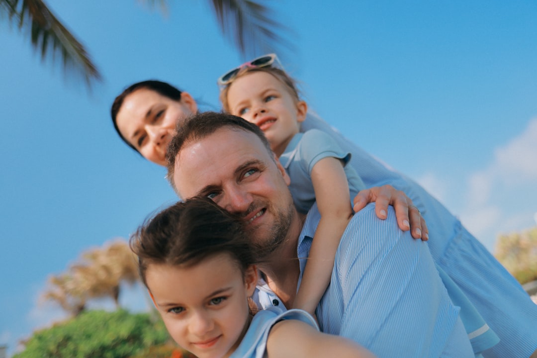 Family smiles together on a sunny day